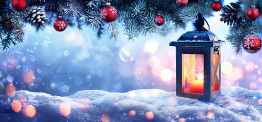 Wall Mural - christmas lantern on snow with snowy fir branches and baubles