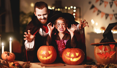 Wall Mural - happy family   father and child daughter in costumes and makeup on  Halloween.