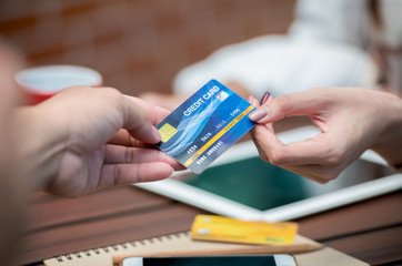 close up two hands of a business person holding a credit card