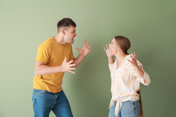 Poster - Portrait of quarrelling couple on color background