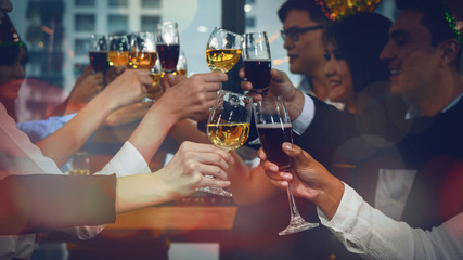 group of business people enjoying party and clinking glass of champagne and wine together to celebrate corporate success and new year event