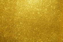Gold Sparkling Lights Festive Background With Texture. Abstract Christmas Twinkled Bright Bokeh Defocused And Falling Stars. Winter Card Or Invitation