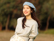 © atiger - Portrait of beautiful Chinese young woman in woolen sweater and blue beret smiling with hands in pocket, charming Chinese girl with black long hair enjoy her leisure time outdoor.