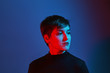 © Branko Starcevic/Stocksy - Portrait of young woman in blue and red light