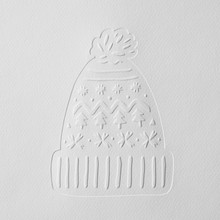 Embossed Pattern On A Gray Cardboard In The Form Of A Hat Decorated With Snowflakes And Christmas Trees With Copy Space. Layout For Christmas Card. Top View