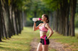 © Olga Mishyna - sport girl making exercises outdoors. Young sport woman in a park. Sport and fitness on open air. Exercise lunge leg on the grass and stretching