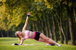 © Olga Mishyna - sport girl making exercises outdoors. Young sport woman in a park. Sport and fitness on open air. Exercise lunge leg on the grass and stretching