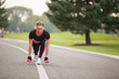 © Olga Mishyna - sport girl making exercises outdoors. Young sport woman in a park