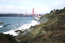 A Wide Shot Of The Coast Where The Pacific Ocean Meets The Golden Gate Bridge