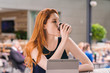 © Gillian Vann/Stocksy - beautiful redhead drinking coffee in cafe