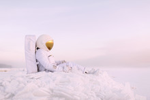 Astronaut Sitting On Cold Planet