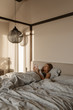 © Milles Studio/Stocksy - Woman chilling in bed with phone