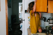 © Maria Manco/Stocksy - child on counter looking in cupboard
