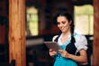 © nicoletaionescu - Oktoberfest Bavarian Waitress Holding PC Tablet Welcoming Guests