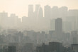 PM2.5 Unhealthy air pollution dust smoke in the urban city. Low visibility city view with dangerous haze and fog.