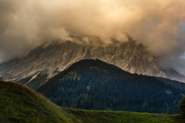 Wall Mural - Misty sunset dawn with sunrays over the Alps, Germany