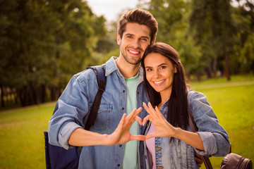 Sticker - Portrait of his he her she nice attractive cheerful tender gentle amorous affectionate married spouses tourists showing heart shape perfect match in green wood forest shiny day sunlight