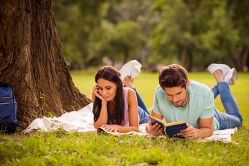 Wall Mural - Her she his he nice attractive lovely smart clever focused concentrated best friends spending weekend free spare time on fresh open air lying under tree on veil cover outside