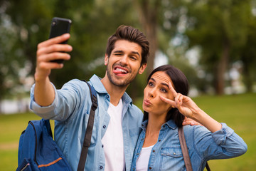 Sticker - Photo of carefree mood pair using telephone making selfies with v-sign symbol wear casual denim outfit