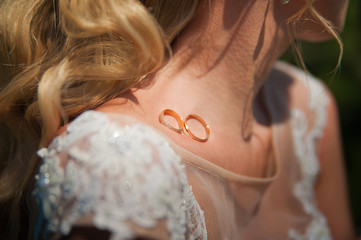 Wall Mural - Wedding rings close up. Rings on the clavicle. Clavicle and shoulders of the bride close-up.