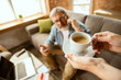 © master1305 - Senior man working with laptop at home - concept of home studying. Caucasian male model sitting on sofa and having coffee break while serfing in internet, watching cinema or webinar, online lessons.