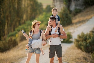 Beautiful family in the mountains. Tourism. Campaign. Fall.