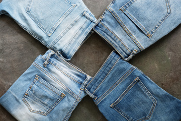 Fashion collection denim blue jeans stacked. Creative jeans background. Top view, flat lay.