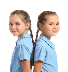 Wall Mural - Portrait of cute twin girls on white background