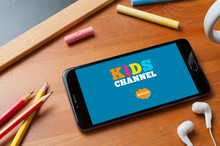 Smartphone Ready To Play A Kids Channel On A Table With Pencils, A Slate With Some Colored Chalks And A Pair Of Earphones