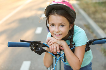 Canvas Print - Cute girl riding bicycle outdoors