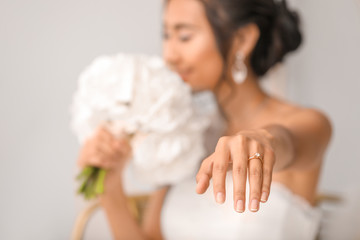 Poster - Beautiful young Asian bride showing her wedding ring