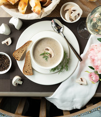 Wall Mural - Creamy mushroom soup with slices of bread and a branch of dill