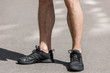 © LIGHTFIELD STUDIOS - cropped view of sportsman in black sneakers on street
