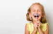 Free time for fun. Close up portrait of fancy, small girl with fake paper mustache cheerfully laughs isolated on grey background with copy space for text. movember