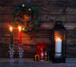 Christmas candles and decorations with toy Santa Claus in dark interior.Cristmas concept. New Year concept. Cristmas background.