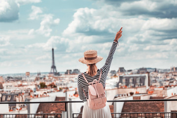 Wall Mural - Happy Asian girl enjoys a Grand view of Paris from the height of the observation deck