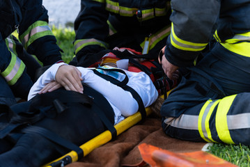 The victim in a car accident lies on a stretcher