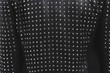 Back of a black leather jacket with metal rivets. Biker or punk studded style. Sample of stylish clothing products. Textured background. Fashionable rocker clothes. Horizontal photo.