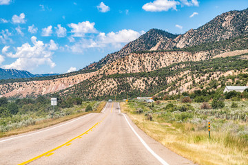 Canyon mountains near Rifle, Colorado with cars on road during sunny summer day with blue sky in desert landscape