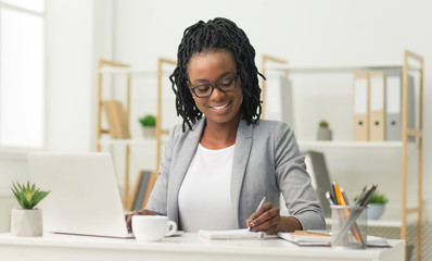 Poster - Black Office Girl Sitting At Laptop Taking Notes At Work