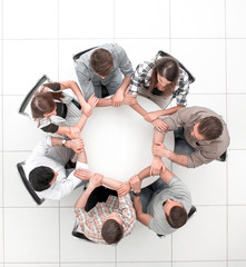 Wall Mural - top view.The business team hold hands, forming a circle