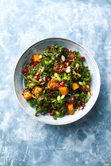 Poster - Hokkaido pumpkin and quinoa salad with kale, pomegranate, spring onion and toasted sunflower seeds. Healthy homemade food. Vegan food