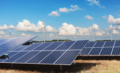 Wall Mural - electricity power in nature. clean energy concept. solar panel with turbine and blue sky background
