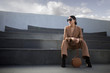 © Alena - Fashion portrait of a successful business woman sitting on stairs. City background