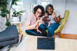 © Cavan Images - Smiling lesbians with baby enjoying video call on digital tablet at home