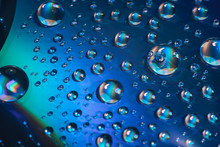 Close Up Colored Water Drops On A Cd Dvd Disk Background.