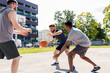 © Syda Productions - sport, leisure games and male friendship concept - group of men or friends playing street basketball