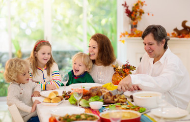 Wall Mural - Family with kids at Thanksgiving dinner. Turkey.