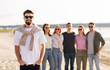 © Syda Productions - friendship, leisure and people concept - happy man with group of friends on beach in summer
