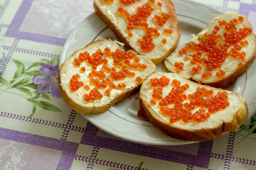 Sandwich - white bread with red caviar.